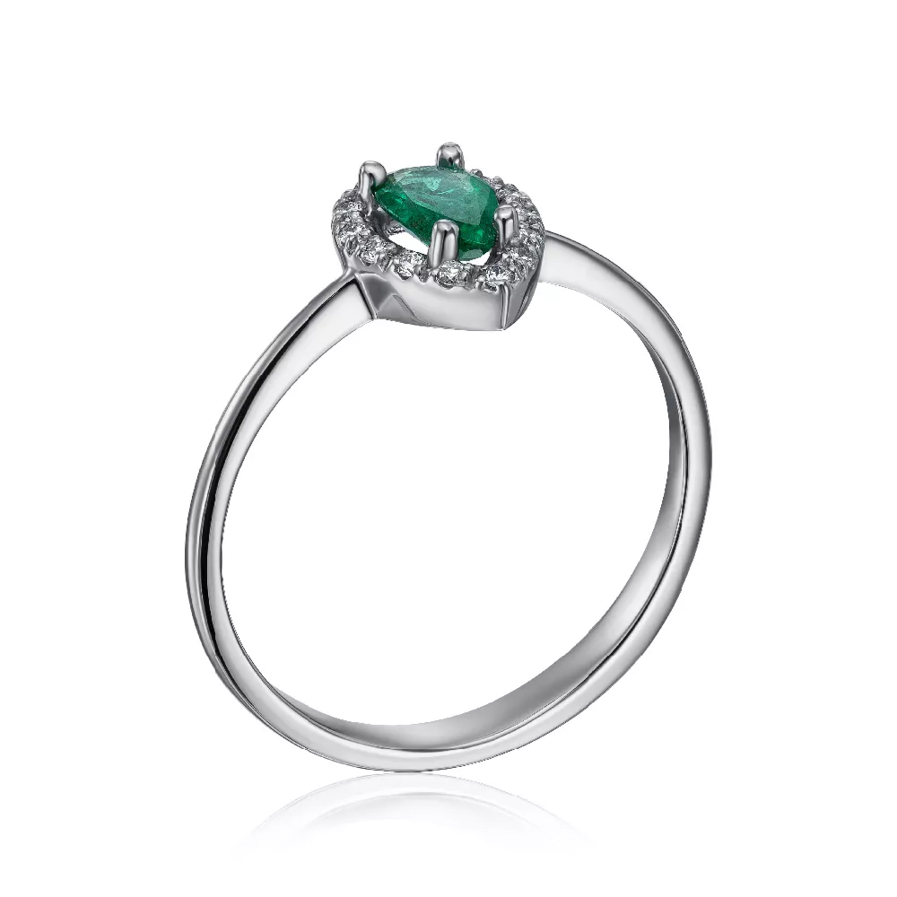 A gold ring with diamonds and an emerald