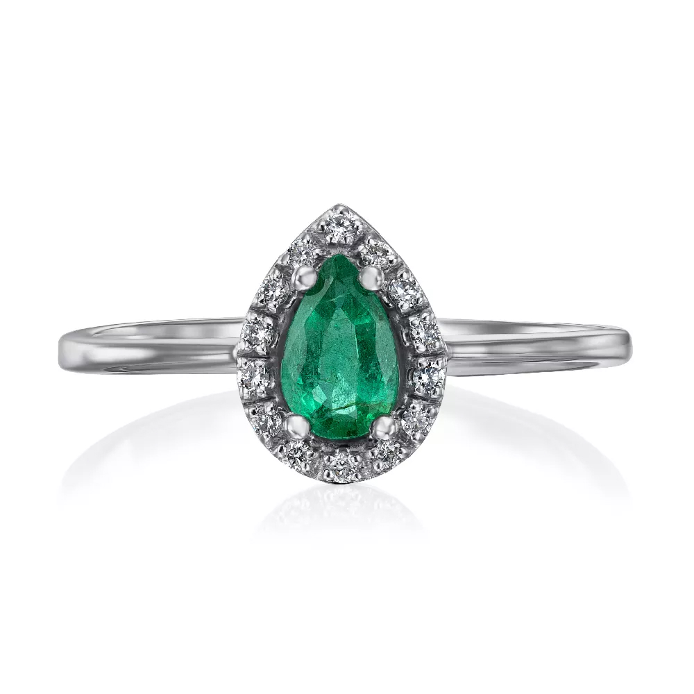 A gold ring with diamonds and an emerald