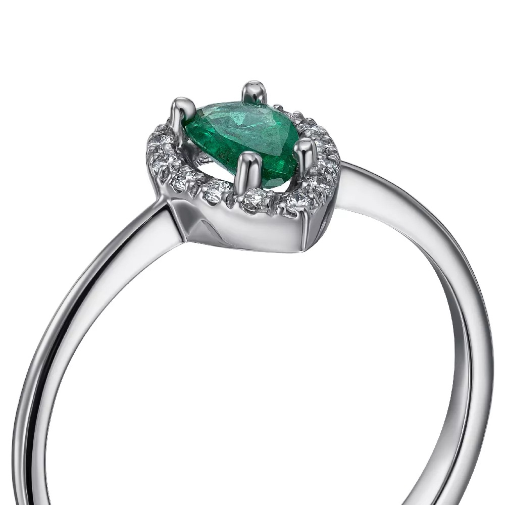 A gold ring with diamonds and an emerald